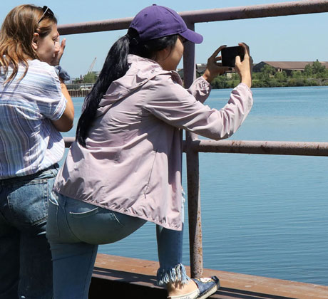 Students taking photo of a lake.