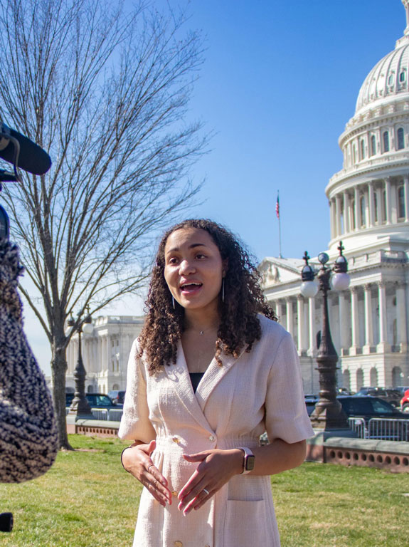 Student reporting outside of the Capitol.