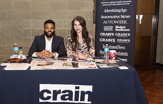 Career fair with a table for Crain.