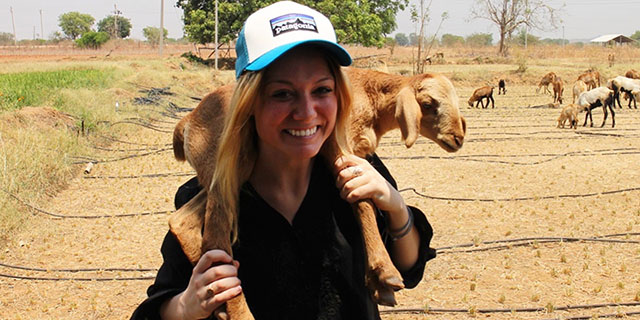 Comer scholar Janice Cantieri with a baby goat around her neck during a reporting trip to India.