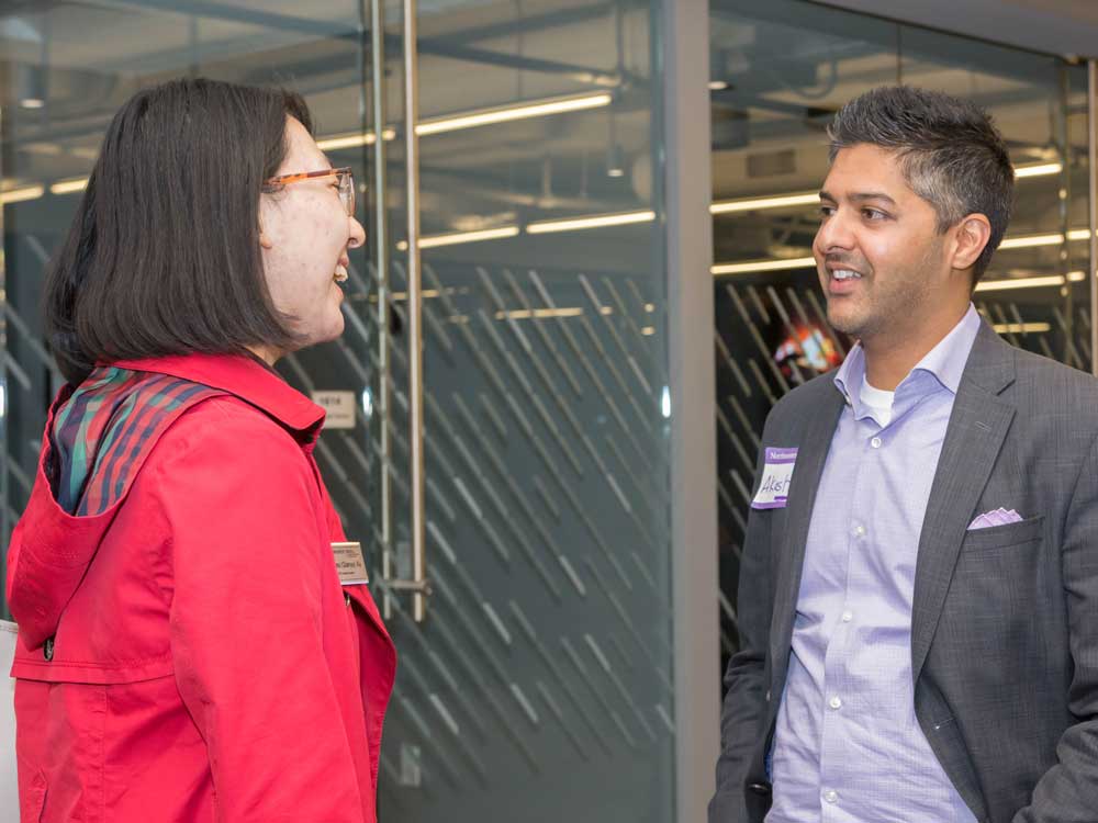 A student talks with alumnus Akash Pathak at Medill Chicago