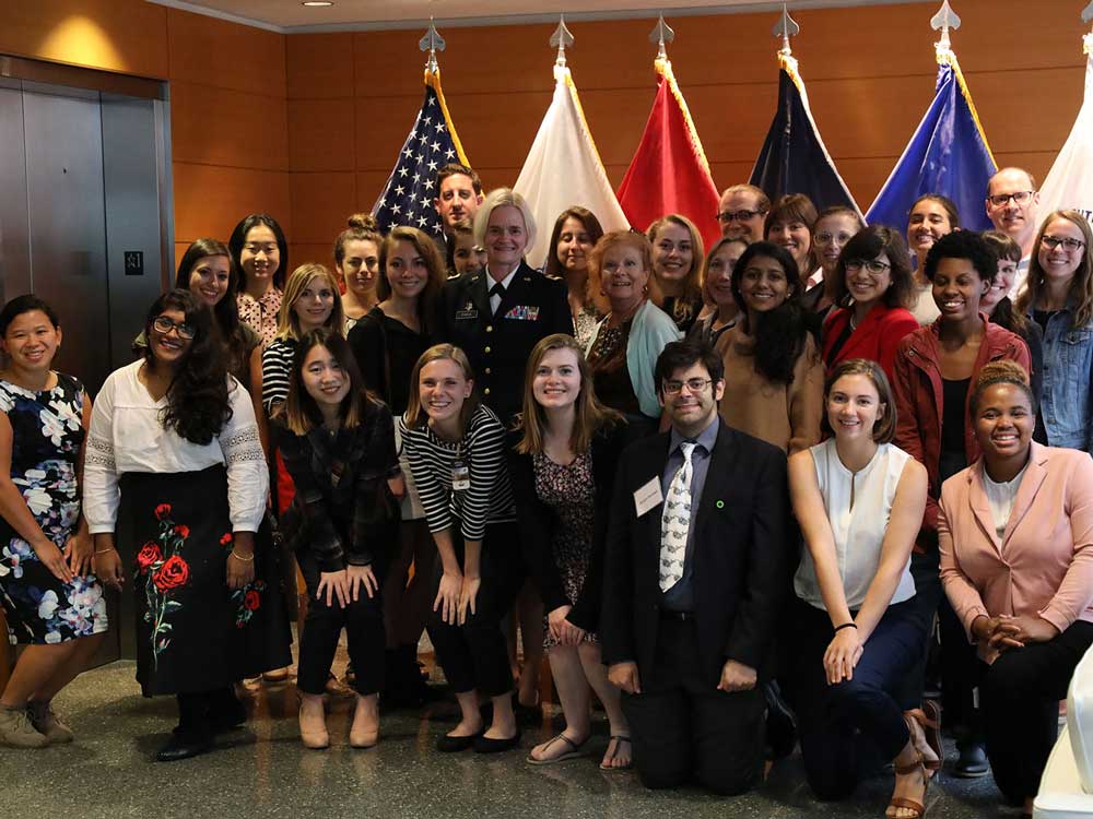 A group of students pose for a photo at Defense Health Headquarters