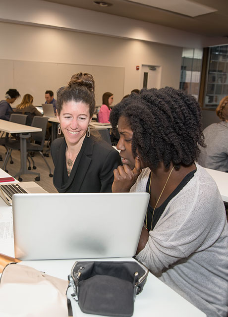 Two women looking at a computer screen.