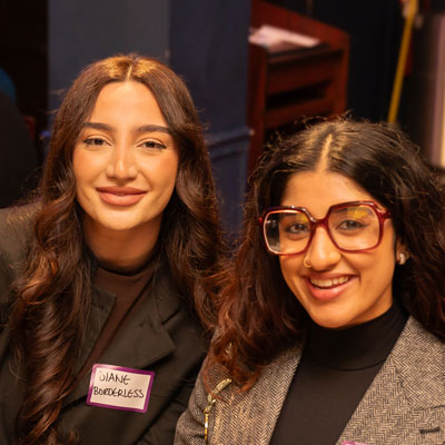 Two women dressed professionally. 