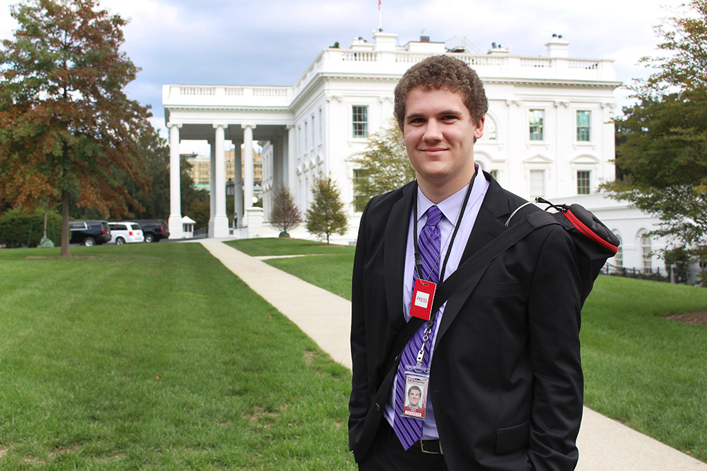 Student reporting in front of the White House in D.C.