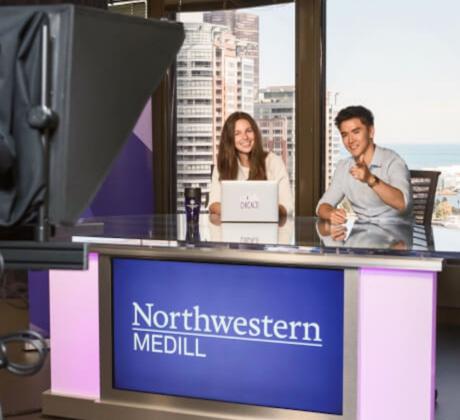 Students doing broadcast journalism on Northwestern Medill desk.