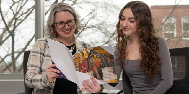 A student sitting at a table with a career advisor.