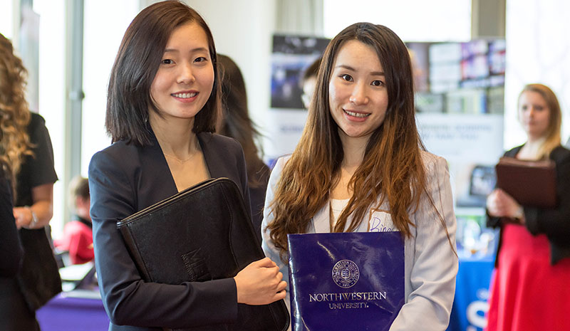 Students holding folders at the career fair