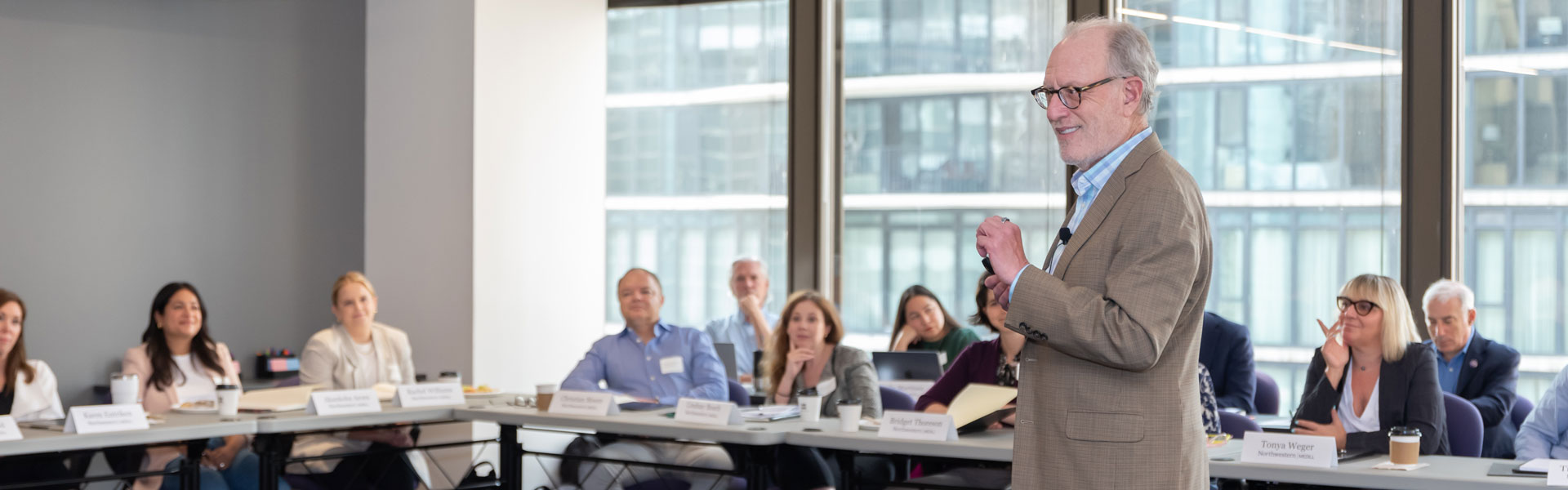 A man in a suit giving a presentation.
