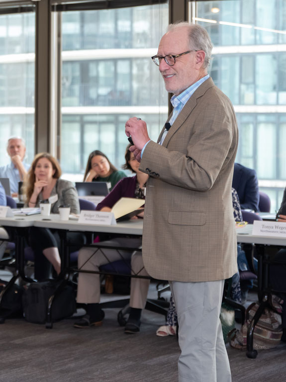 A man in a suit giving a presentation.