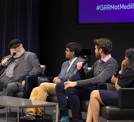 George R. R. Martin giving a lecture to students.