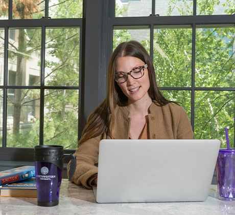 Woman working on a laptop.