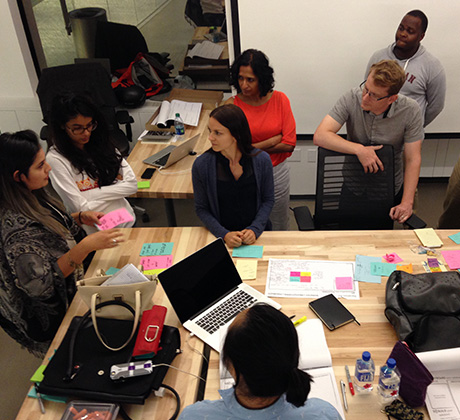 Students gathered around a table working on a project