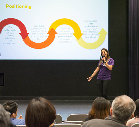 A student gives a marketing strategy presentation