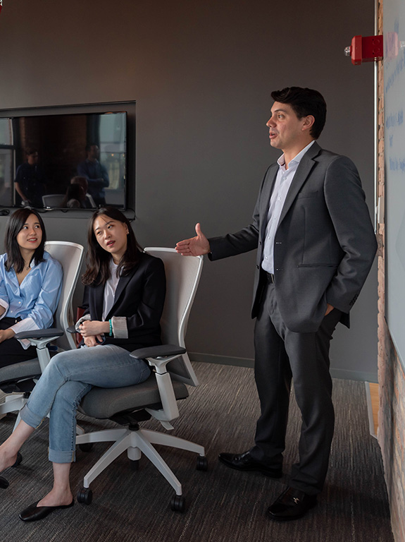 Student gives a presentation to a business client