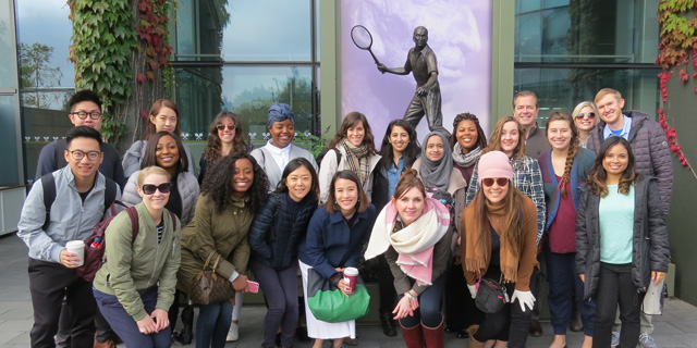 Large group of students posing for photo in front of The All England Lawn Tennis Club