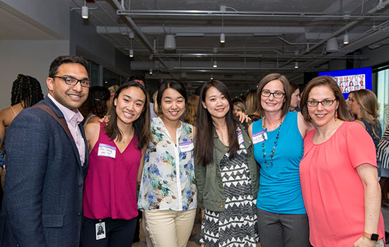 A group of Medill Alumni posing for photo together.