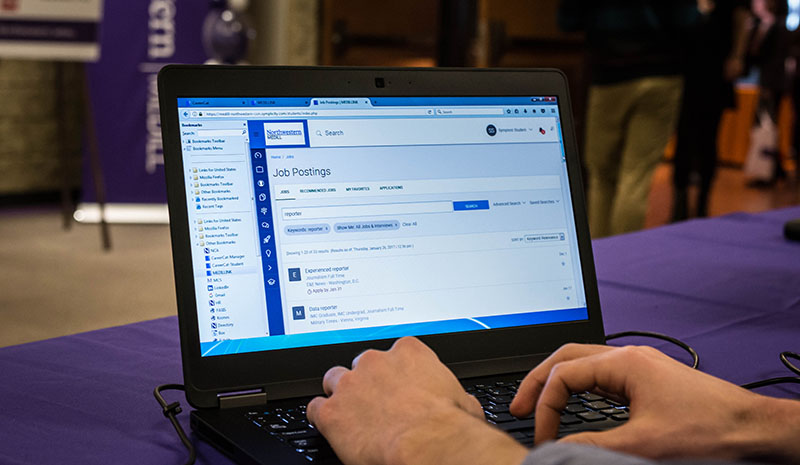 Student looking at job postings on computer