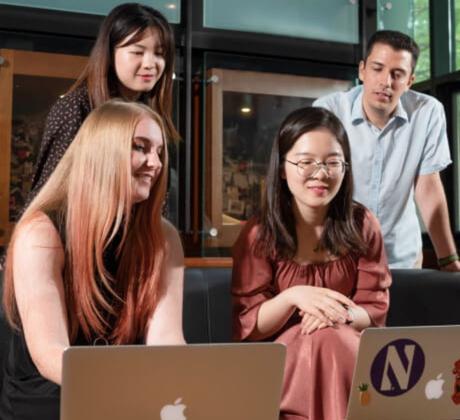 Students working together in front of a computer