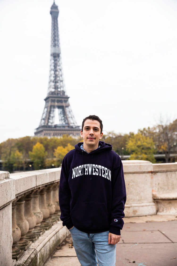 Student in a Northwestern sweatshirt in front of the Eiffel Tower