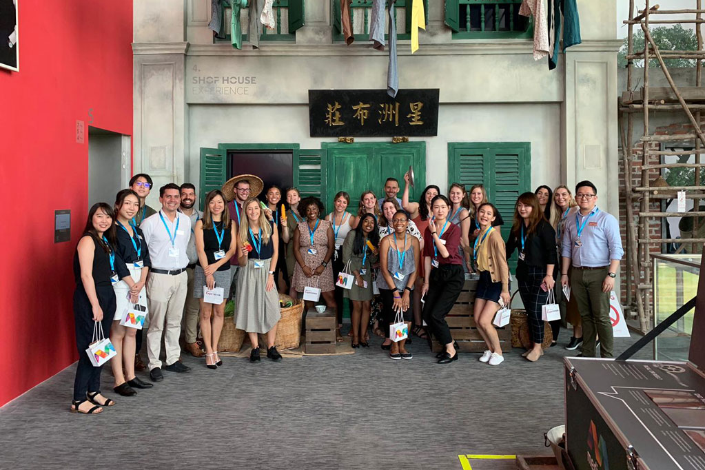 Photo of a group of students outside a company in Asia.