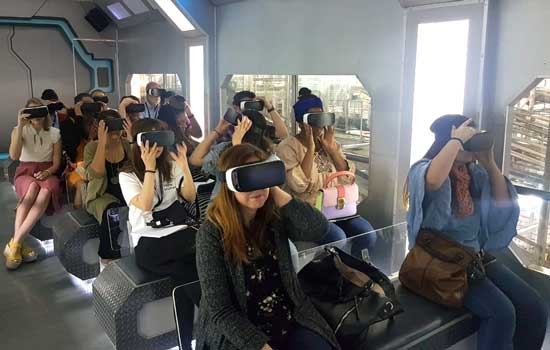 A group of students sit in chairs wearing virtual reality (VR) headsets