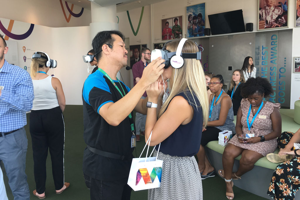 An IMC student tries on a virtual reality headset