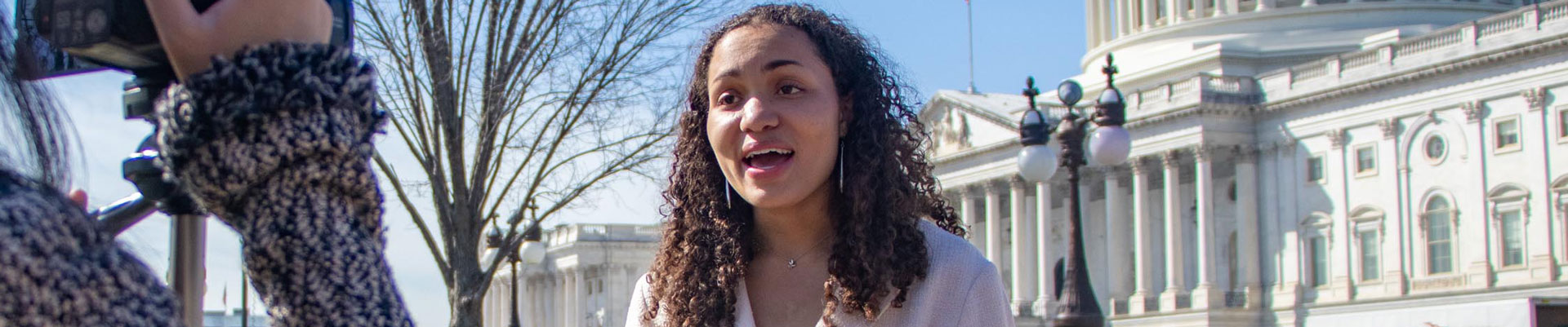 Student reporting outside of the Capitol.