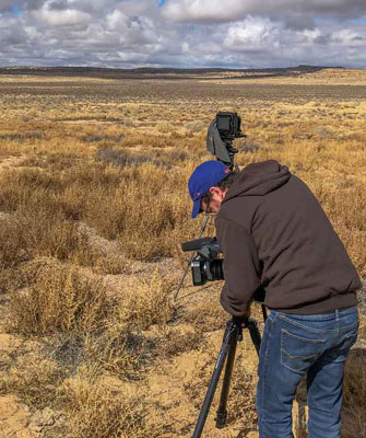 Student films in an open landscape.