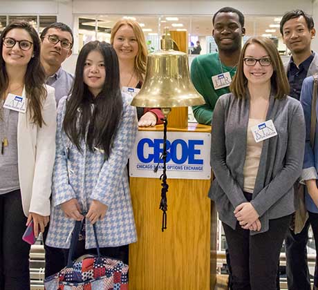 A group of students standing beside the CBOE opening bell.