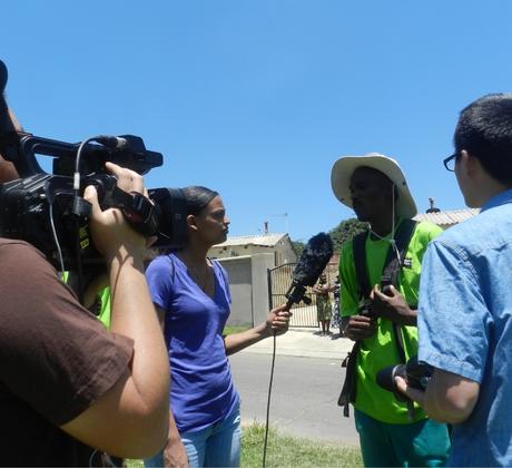 A student interviewing a man.