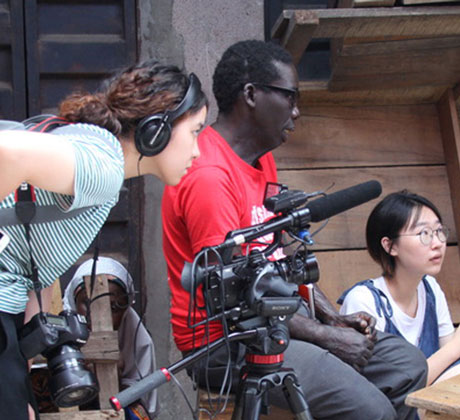 Student interviews woman from behind the camera.