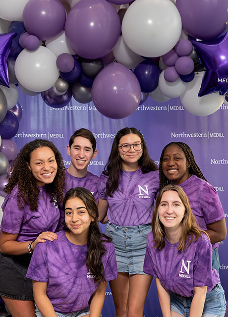 A group of students wearing purple tie-dye t-shirts.