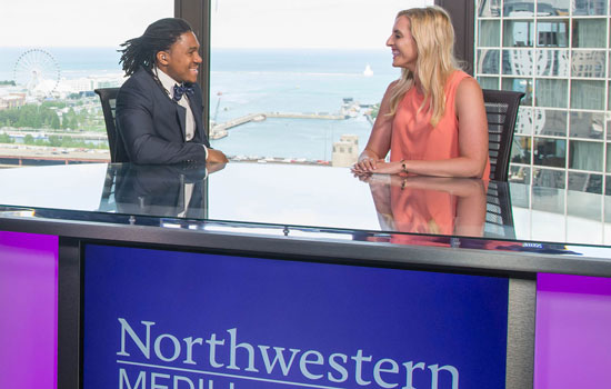 Students at the anchor desk in the downtown Chicago newsroom.