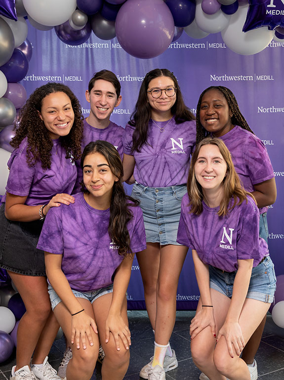 A group of students in purple tie-dye shirts.