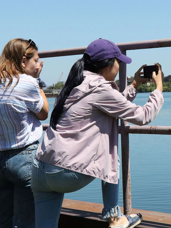 Student photographing a lake