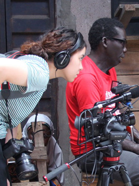 Students interview someone on camera for a documentary.