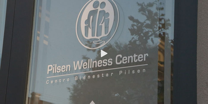 A door with the words Pilsen Wellness Center.