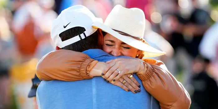 Scottie Scheffler hugs his wife Meredith after winning the WM Phoenix Open for the second straight year at TPC Scottsdale.