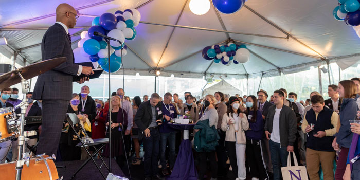 Medill Dean Charles Whitaker speaks to a crowd during the Medill Centennial Celebration.