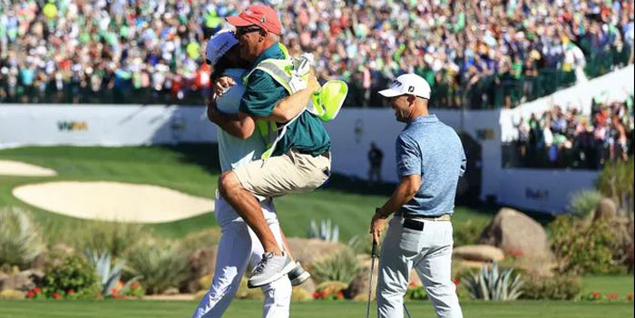 Sam Ryder of the United States reacts to his hole-in-one with his caddie .