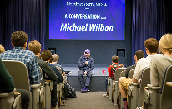 Michael Wilbon speaking to students in a Medill classroom.