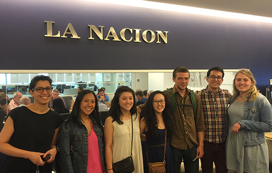 Students standing in front of La Nacion sign.