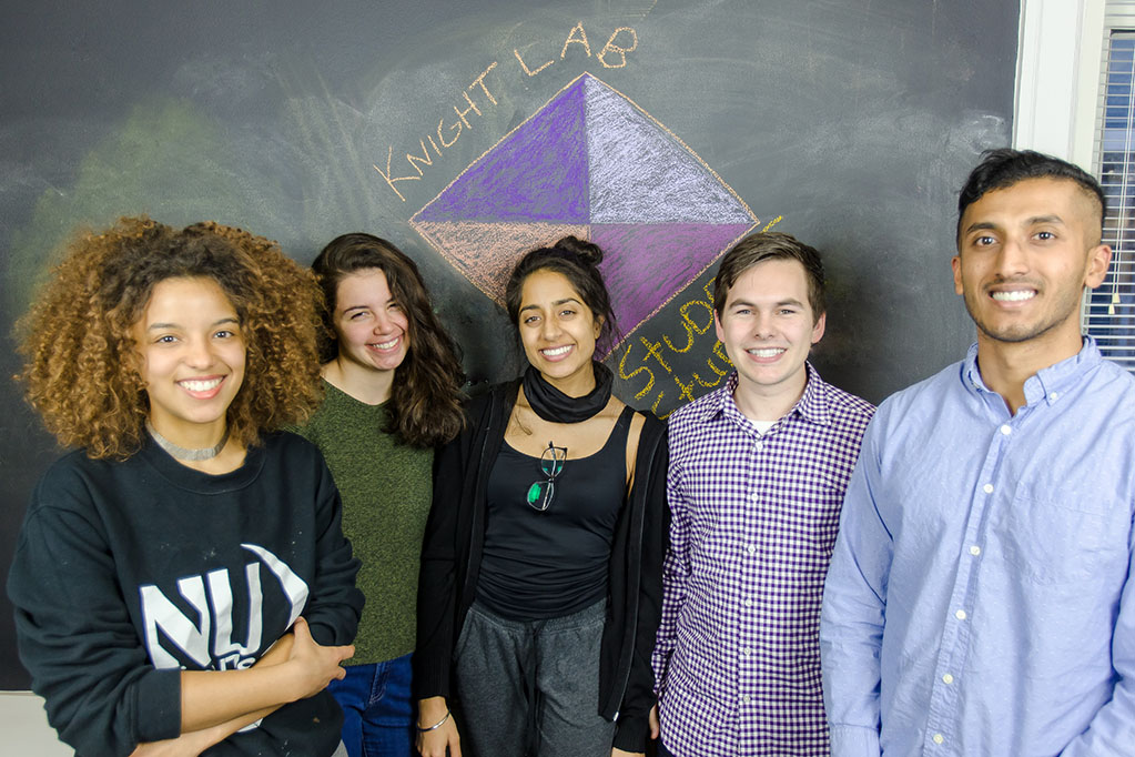 Students in front of a chalkboard in the Knight Lab.