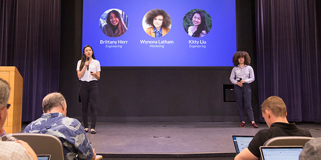 Student giving presentation on stage.