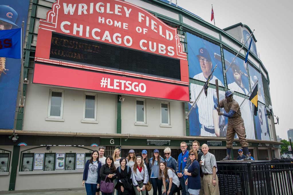 Student pose in front of Wrigley field during a special tour.