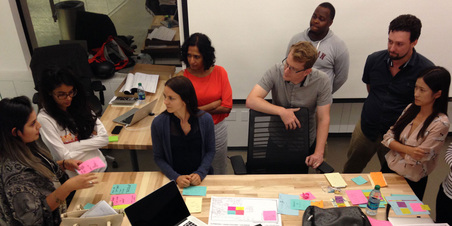 Students work together around a desk at Medill's San Francisco space.
