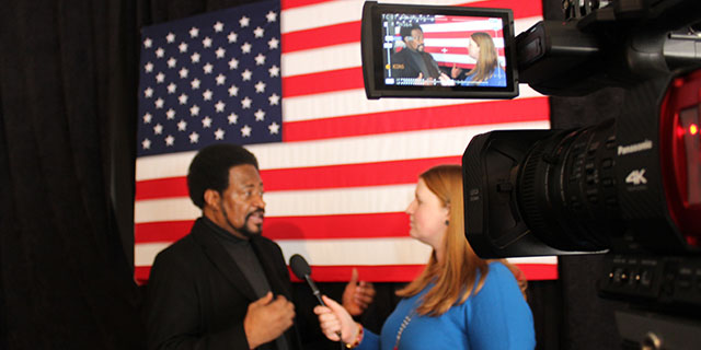 Student interviewing someone on camera.