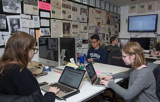Students working at the student newspaper office on campus.