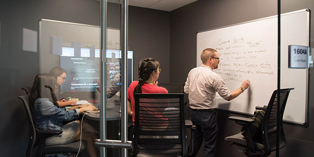 Students working on a project in an office.